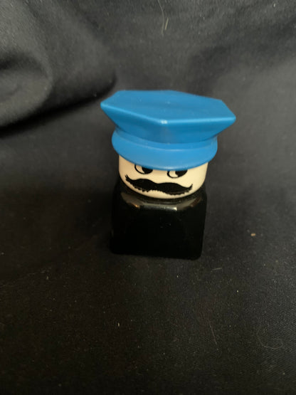 Blue plastic lego minifigure head with black mustache and eyes wearing a blue cap from toys 001 collection