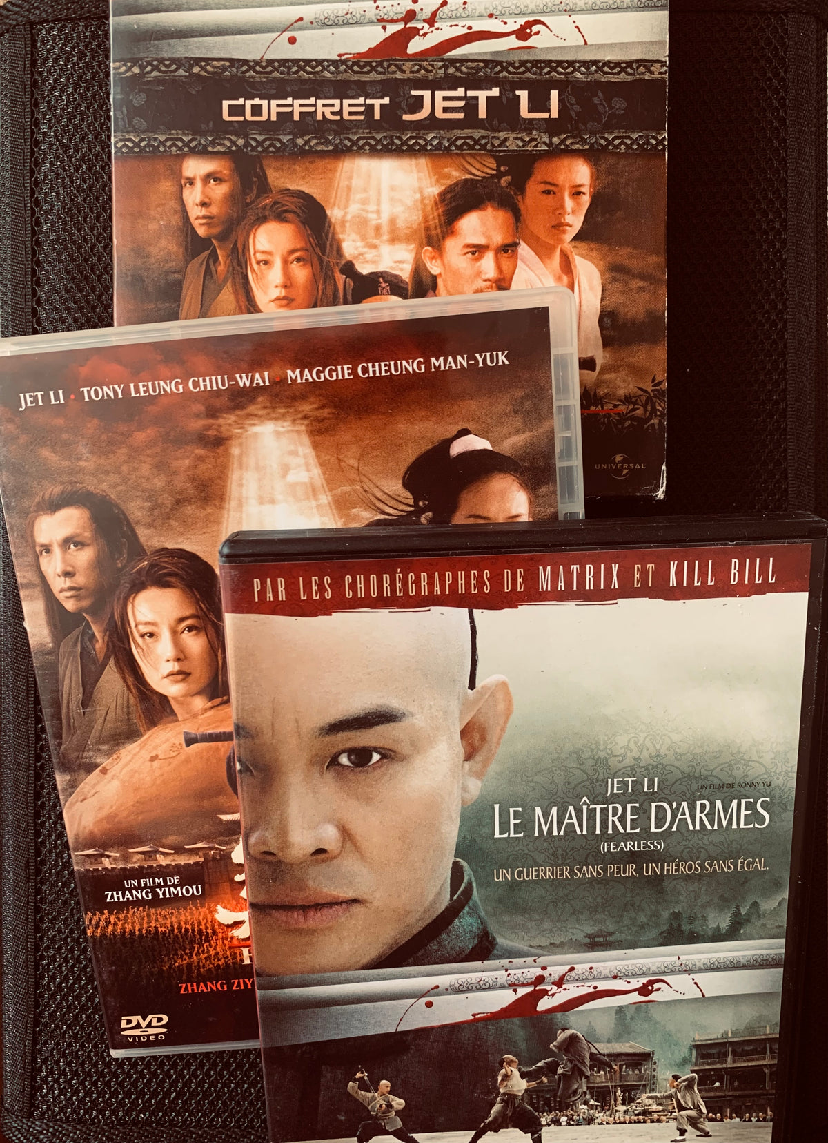 Dvd 3 coffrets featuring Jet Li the master of martial arts fearless with close-up portrait and red splatter design