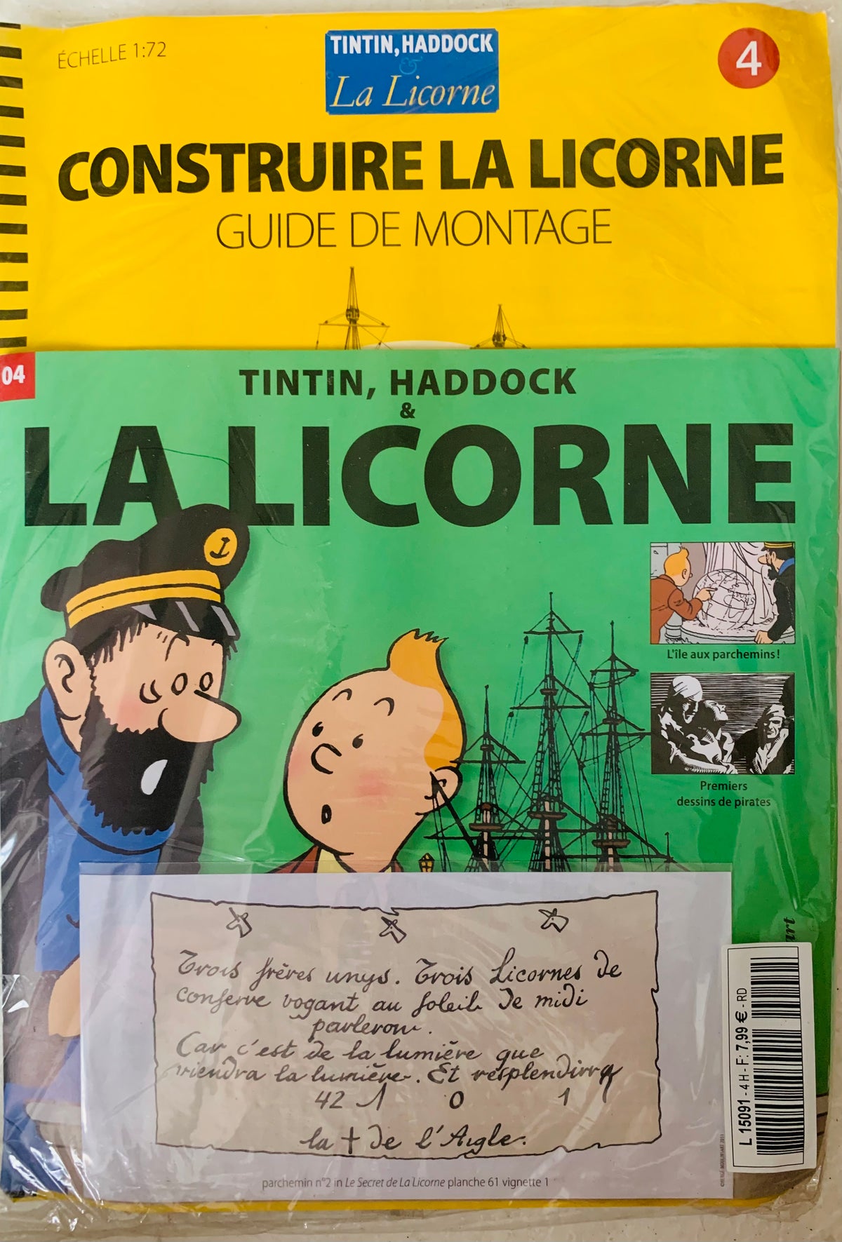 Yellow and green illustrated booklet titled construire la licorne featuring tintin and captain haddock with barcode on right
