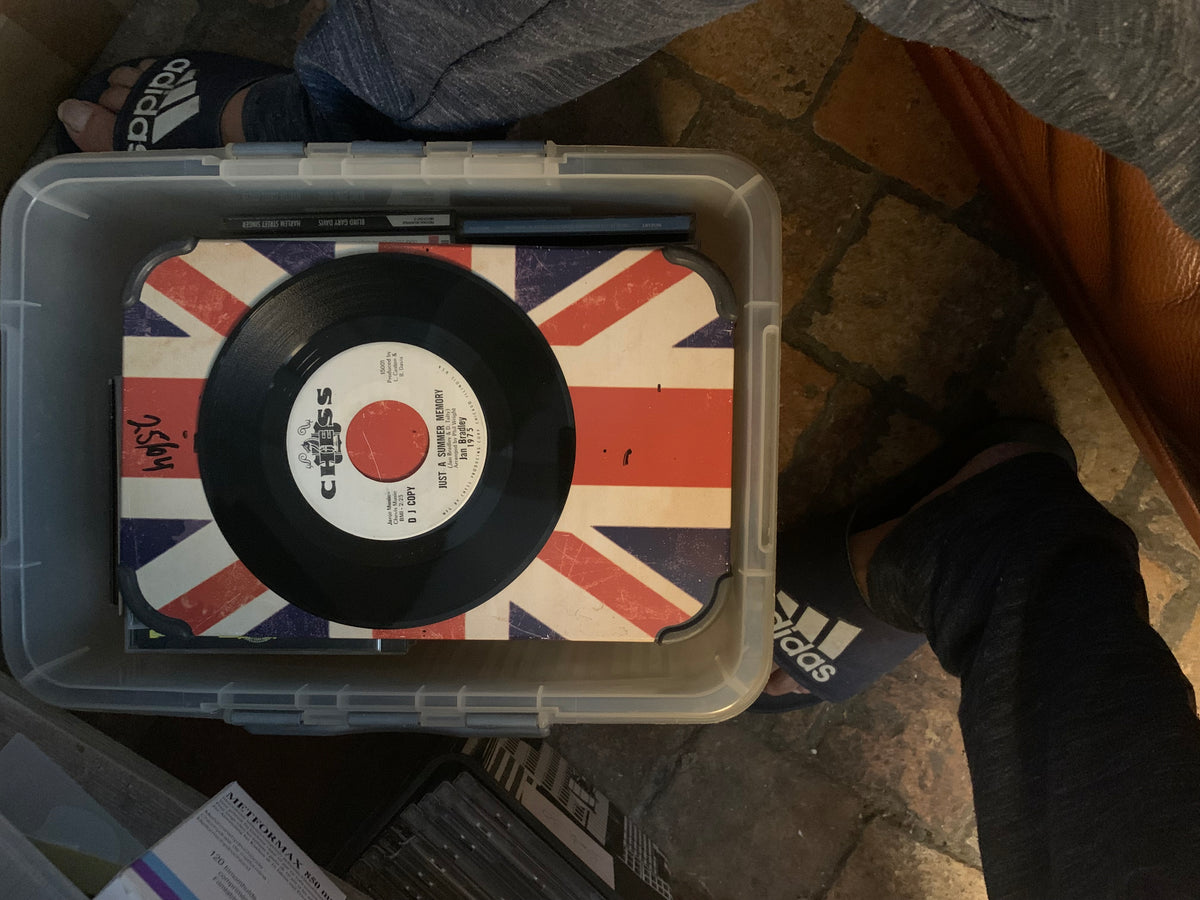 A black vinyl record with a white label and red center chess logo on a union jack sleeve for the soul 7 product
