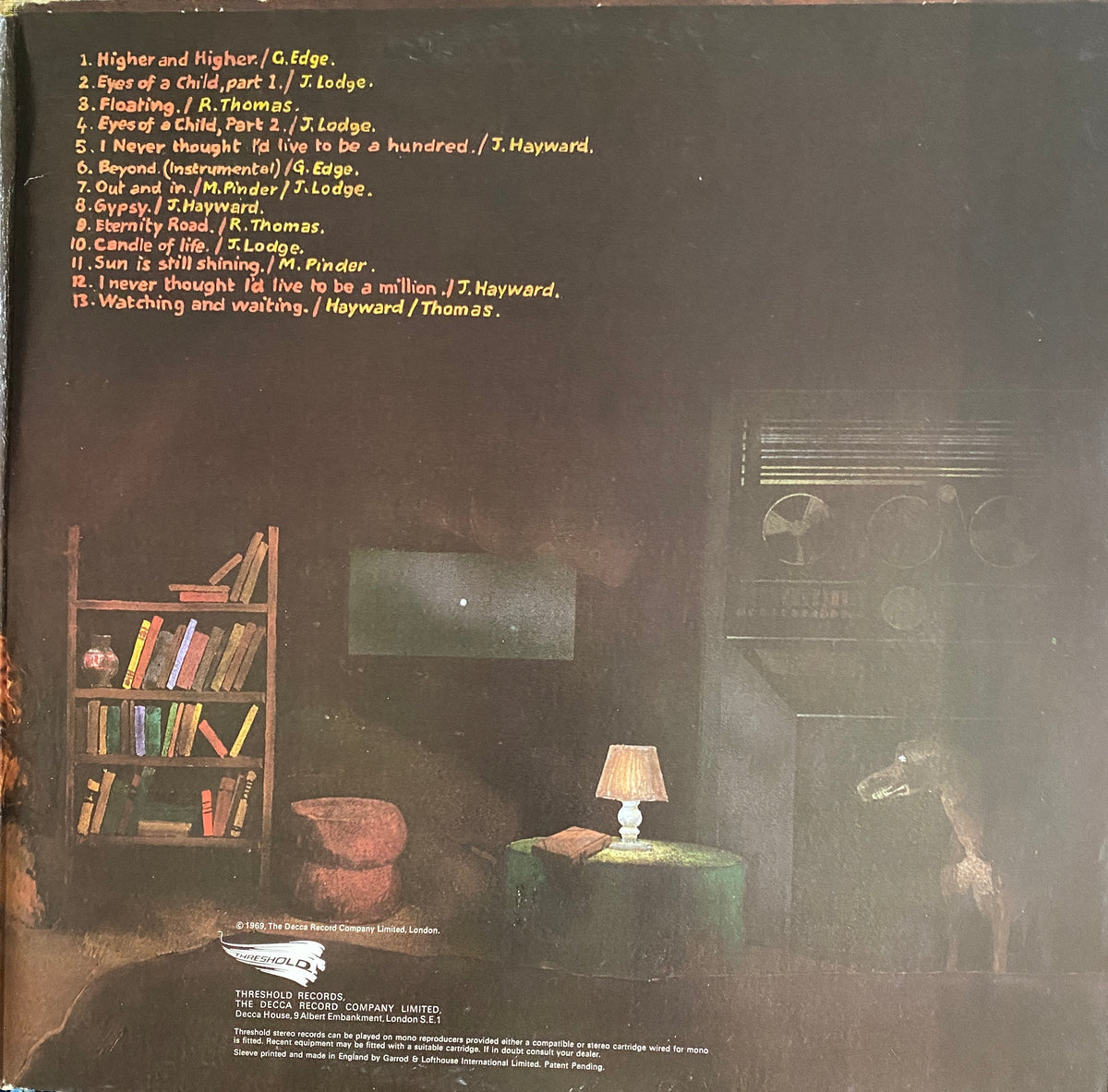 Darkly lit album cover for the moody blues to our childrens childrens children featuring vintage radio and giraffe figurine