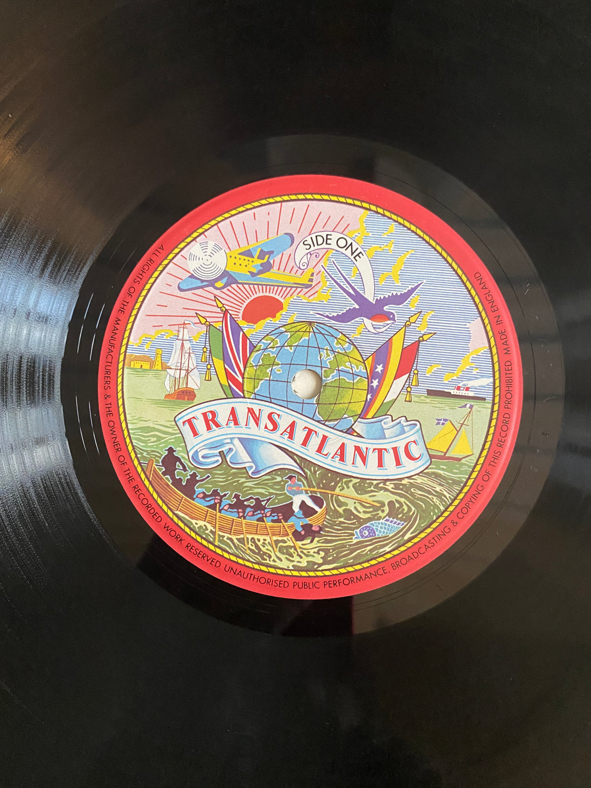 A vibrant illustrated vinyl record label for the album transatlantic by Side One on Various Artists The Black Mikado LP