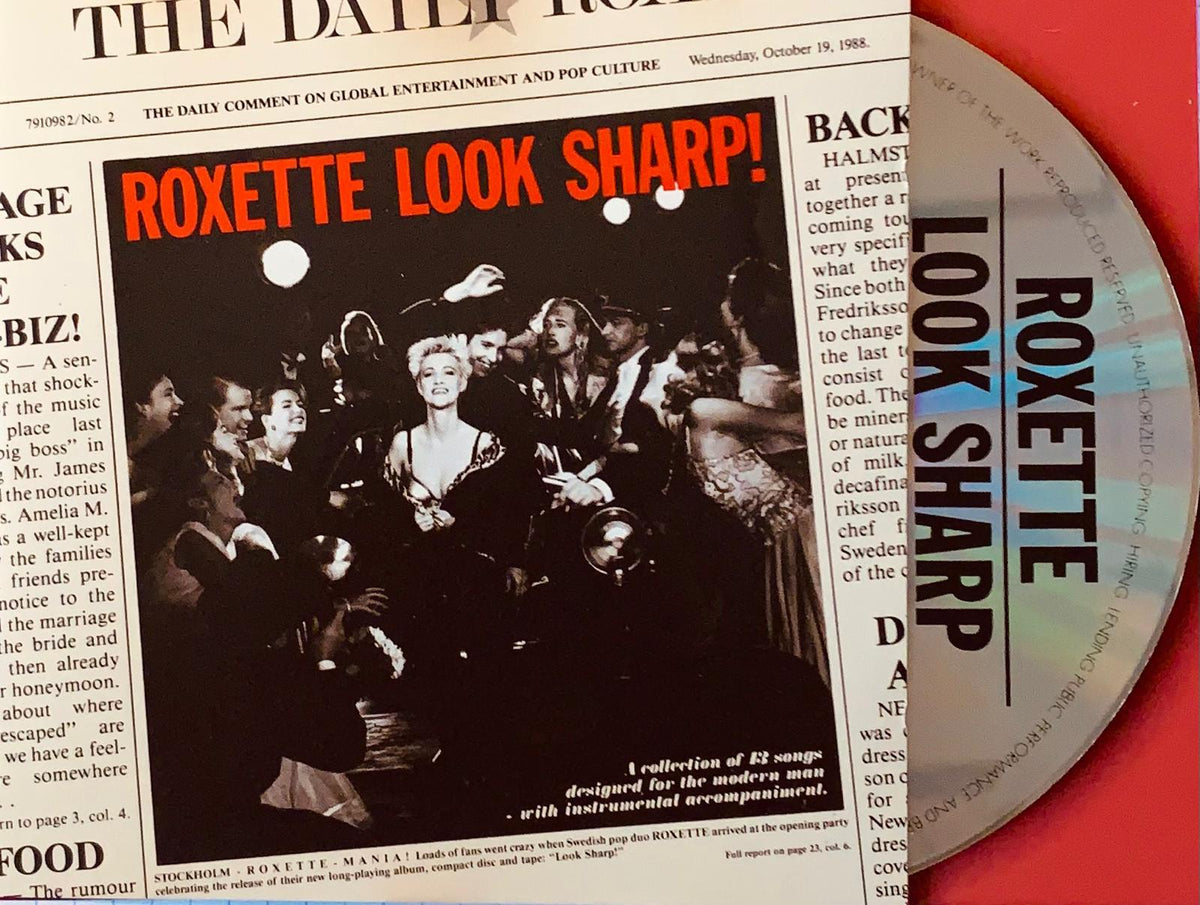 The silver compact disc features black lettering with the band roxette and album title Look Sharp! on the front