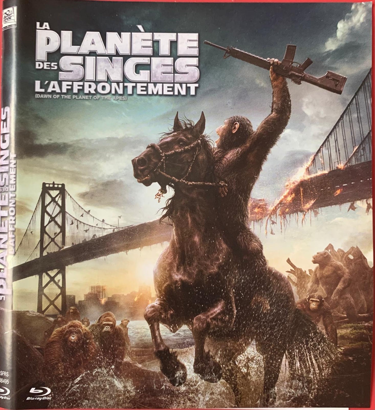 The blu-ray cover for dawn of the planet of the apes features a dark-furred ape on a black horse holding an assault rifle