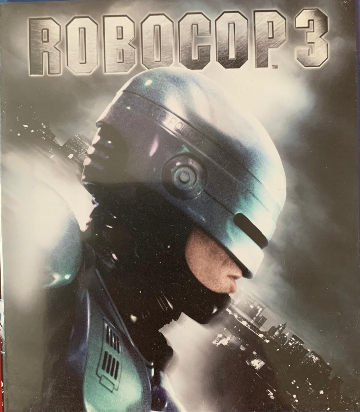 The metallic futuristic helmet of RoboCop with a sleek blue and silver finish featured in RoboCop 3 Blu-ray