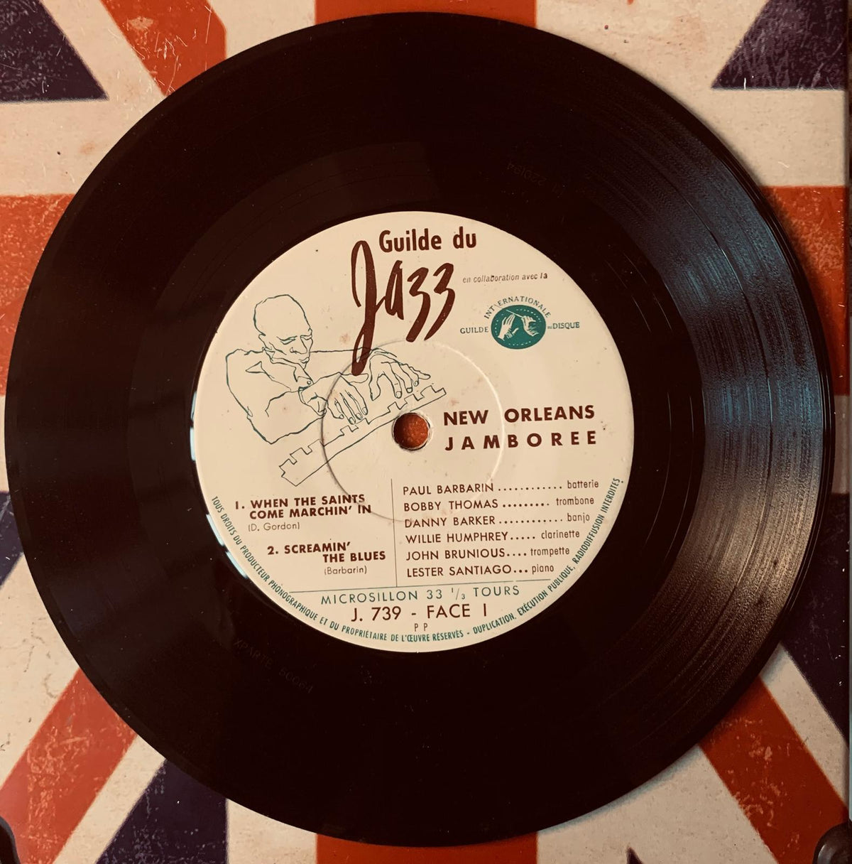 Black vinyl record with white label featuring brown text and jazz musician illustration titled new orleans jamboree guide du jazz