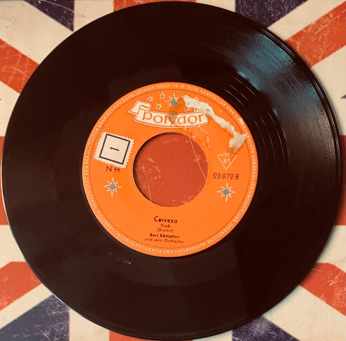 A vintage black vinyl record with an orange polydor label featuring cerveza by bert kämpfer and his orchestra in jim reeves 45t vinyl