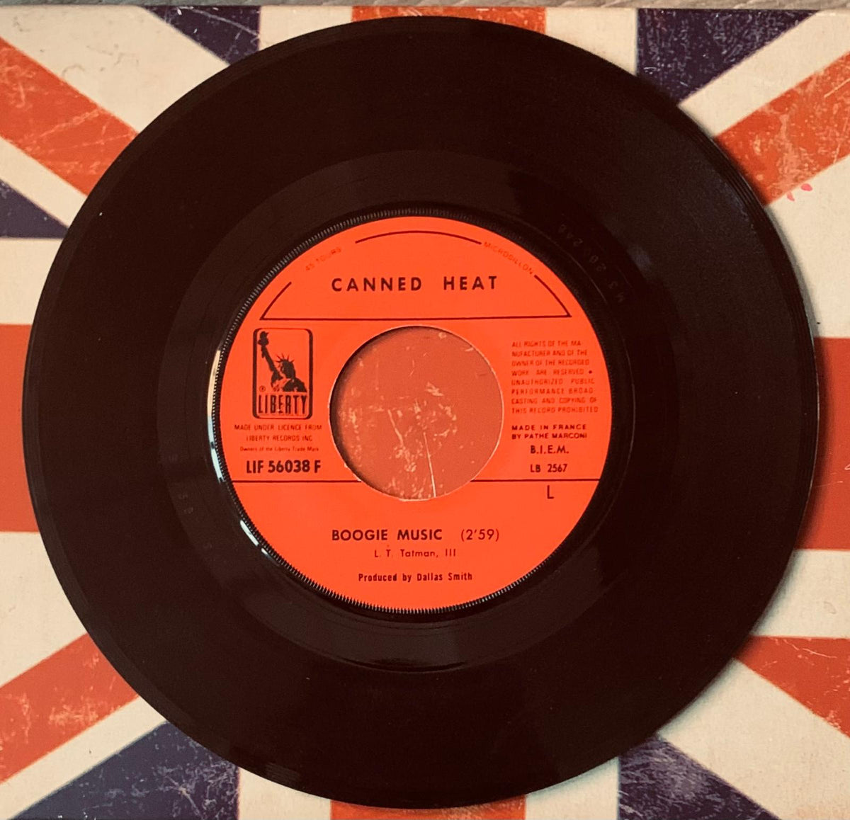 Black vinyl record with vibrant orange label featuring canned heat boogie music by liberty records from original 45t vinyl