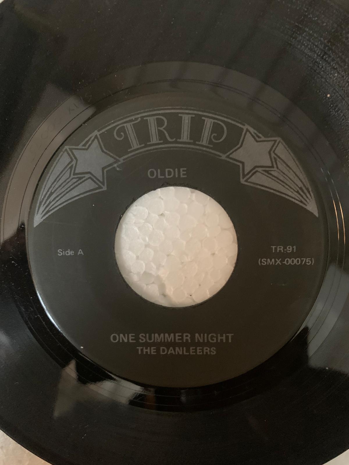 Black vinyl record with silver embossed label featuring one summer night by the danleers original 45t vinyl