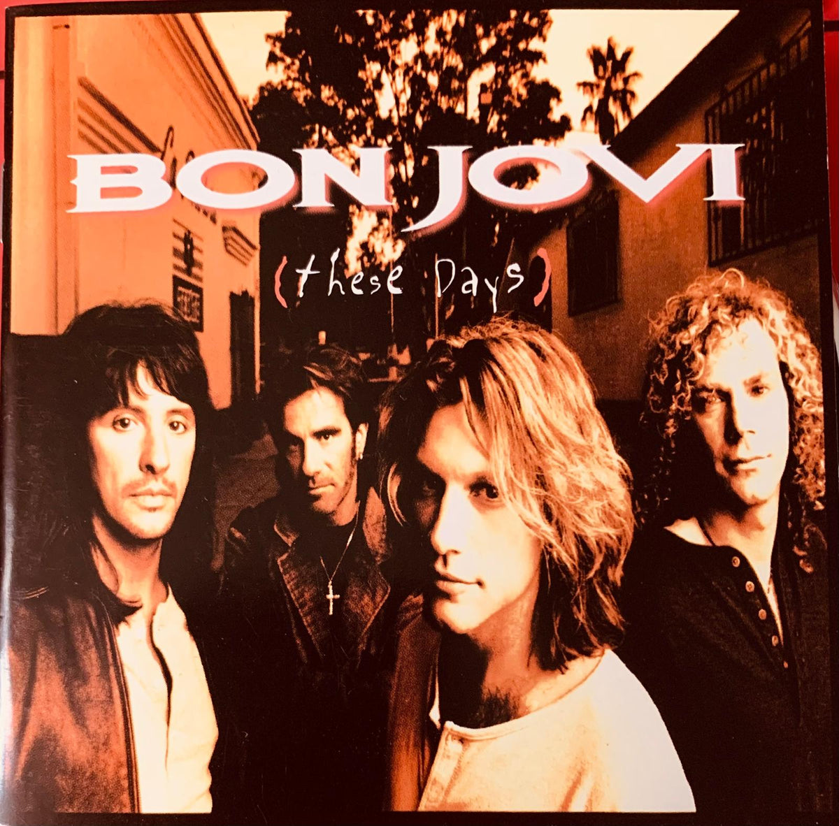 Cd cover of bon jovi these days album showing sepia tone band members with bold white lettering for original cd product