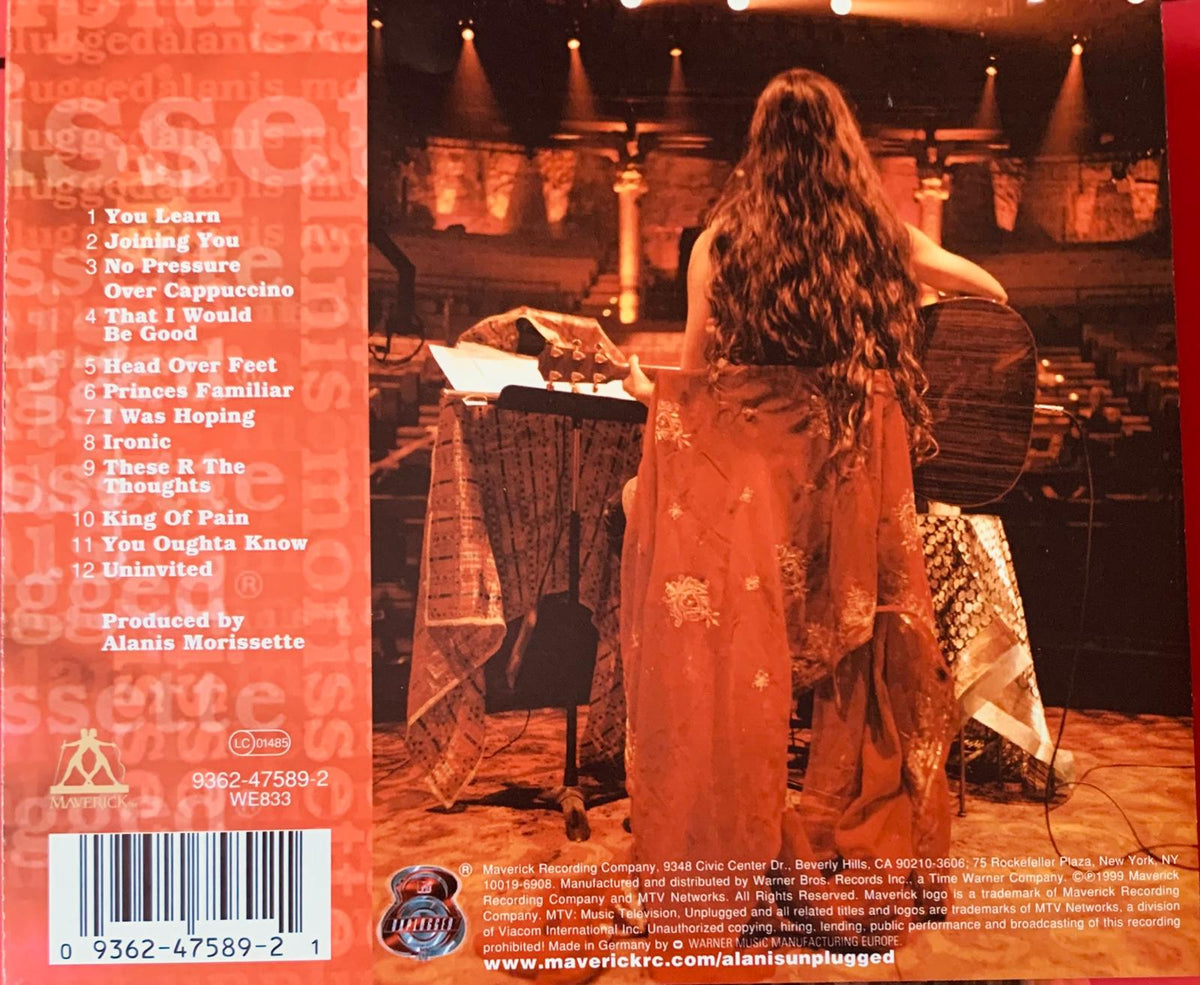 The back cover of alanis morissette mtv unplugged original cd featuring a woman in an orange patterned dress on stage