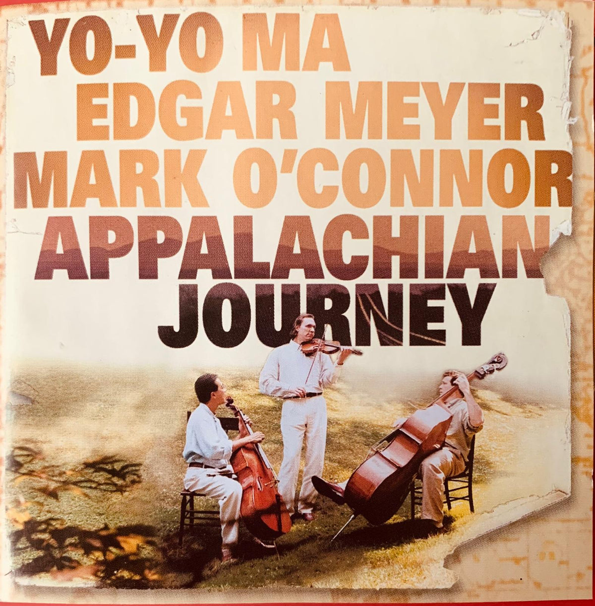 The album cover for Appalachian Journey original CD features sepia vintage design with three musicians playing strings outdoors