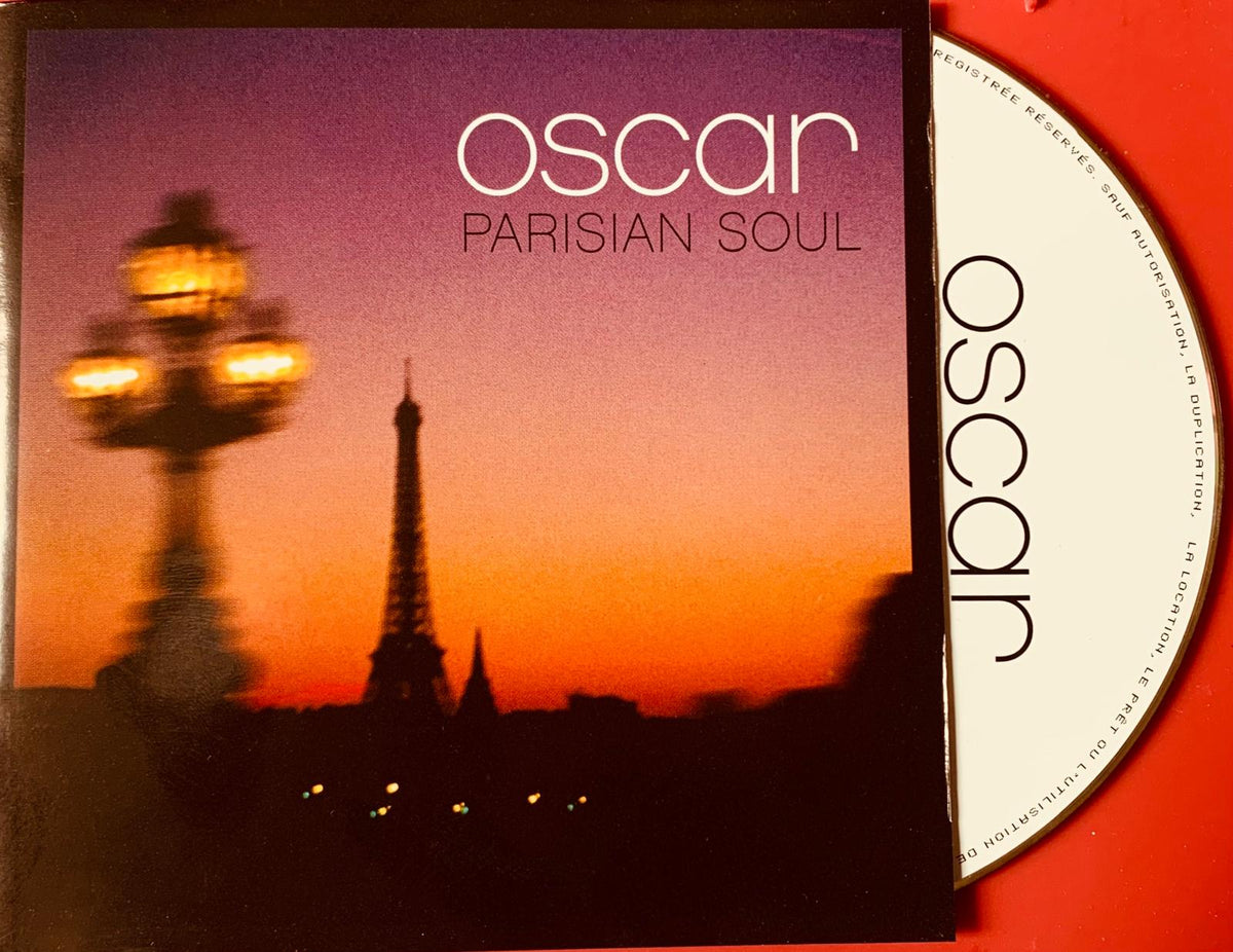 The album cover for oscar parisian soul cd features a blurred glowing streetlamp and eiffel tower at sunset