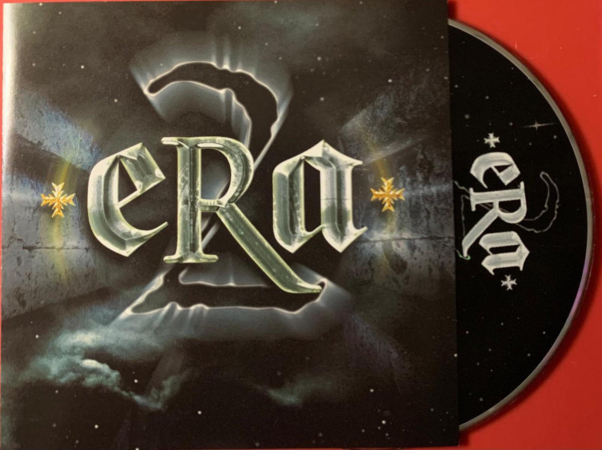 Black cd with silver and gold era lettering partially emerging from matching black sleeve against cosmic background