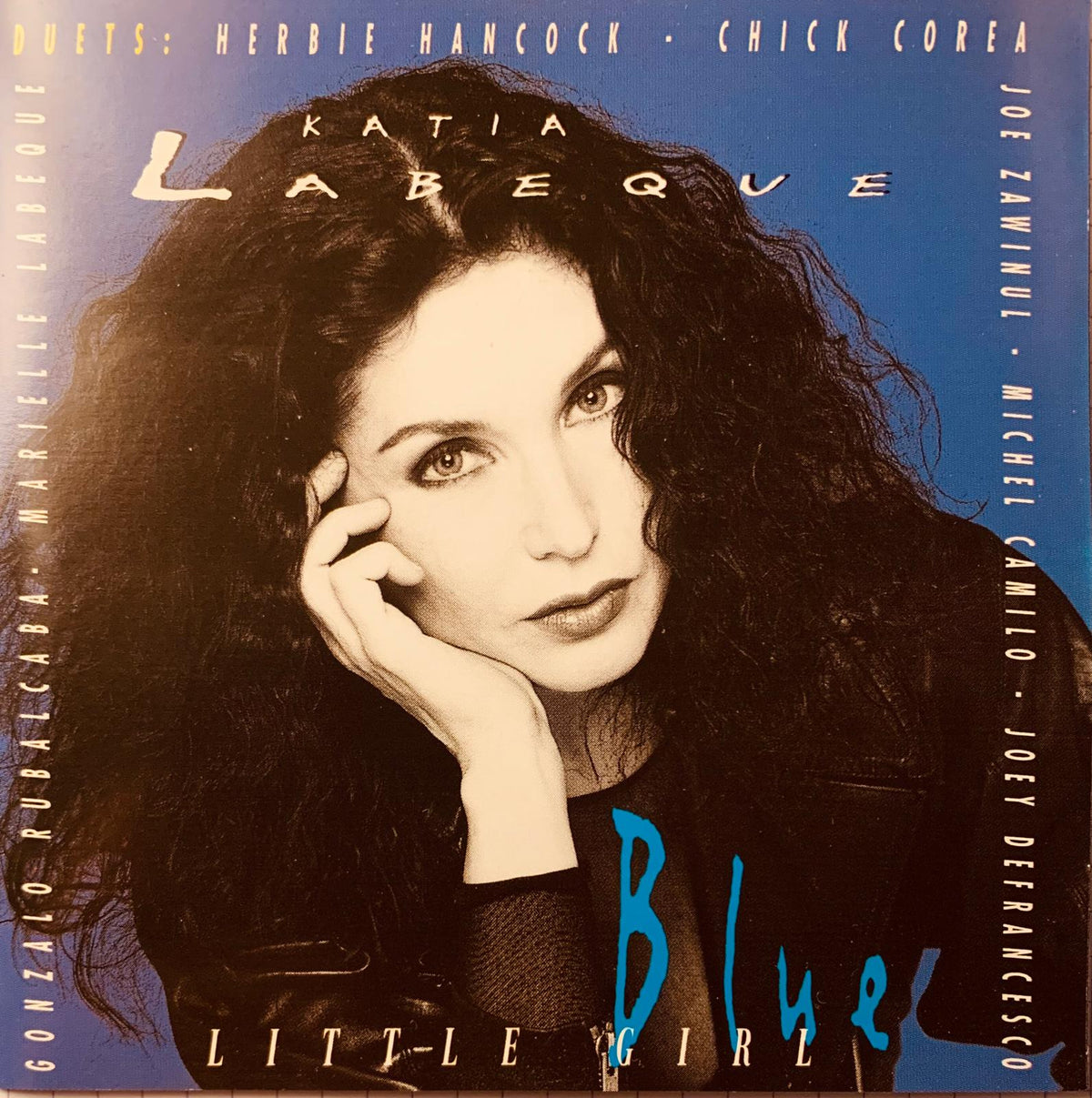 Cd cover of katia labèque little girl blue album featuring a portrait of the artist with dark curly hair on blue background