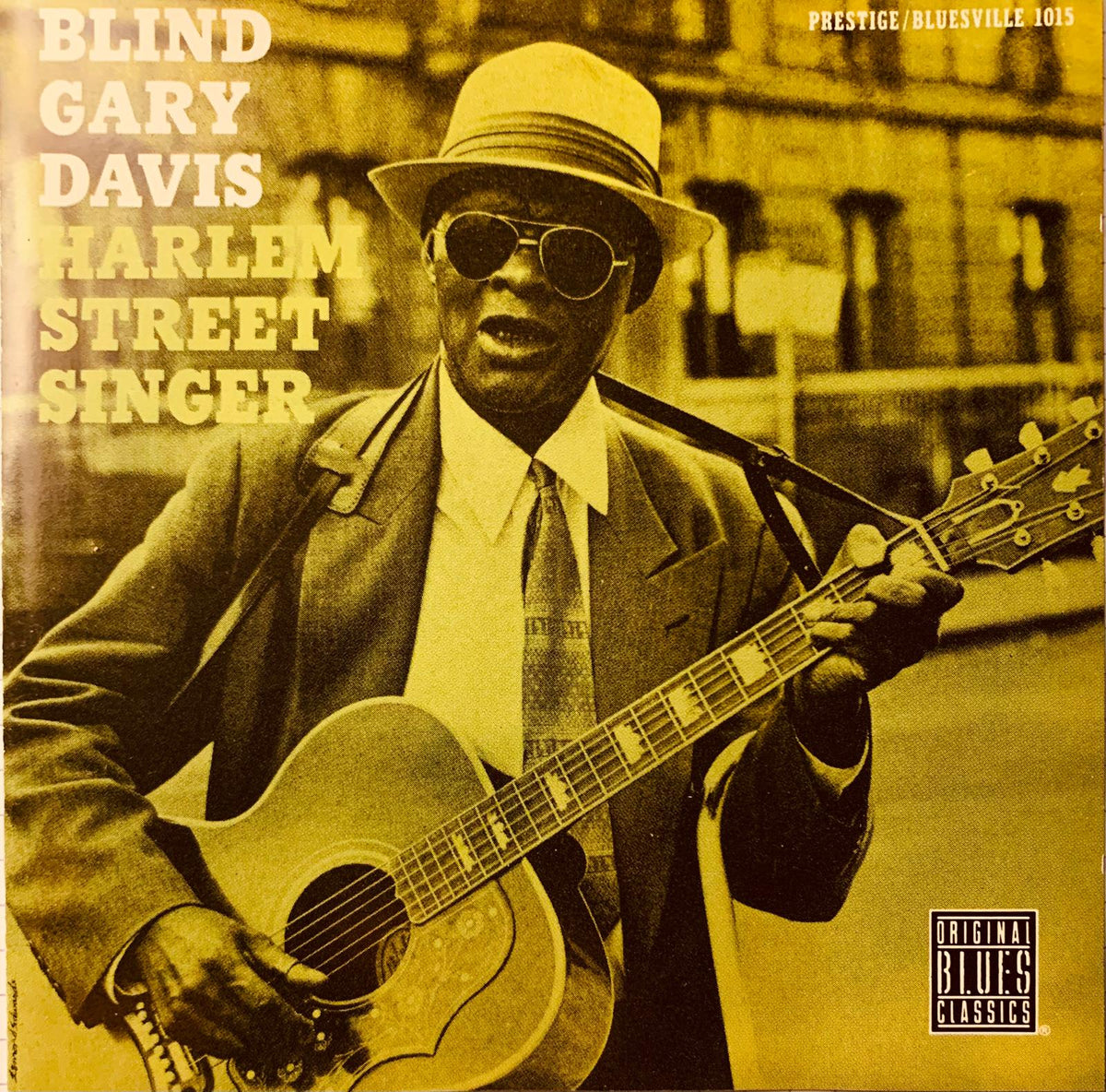 Vintage style album cover for blind gary davis harlem street singer cd with man in fedora holding acoustic guitar in sepia tone