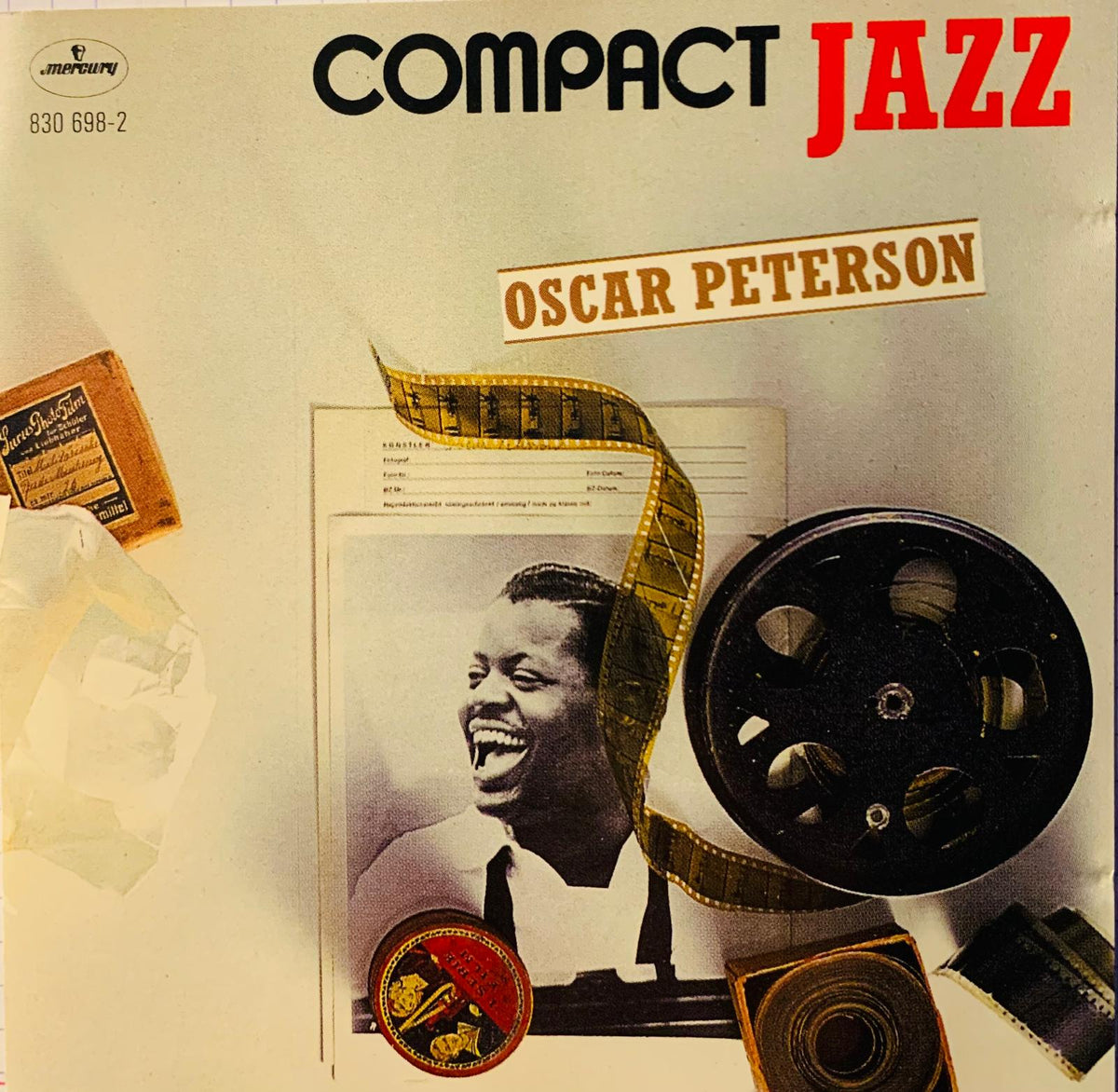 Compact jazz cd featuring oscar peterson with vintage film reel and retro media items around his smiling portrait