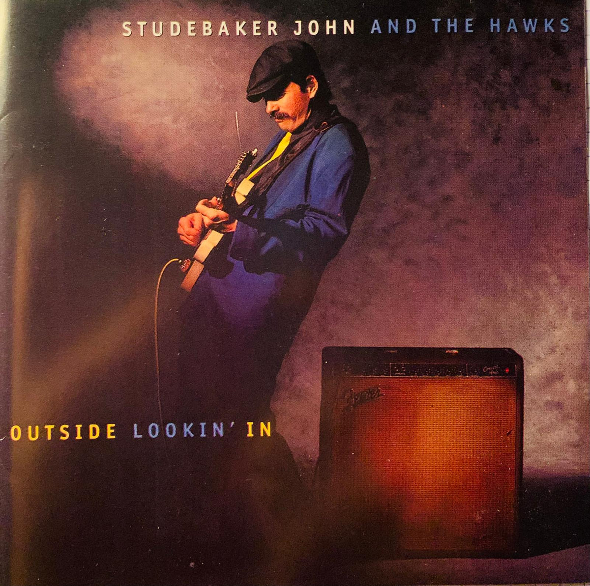 Vintage-style fender amplifier with warm orange-brown grille cloth and dark metal casing for studebaker john and the hawks original cd