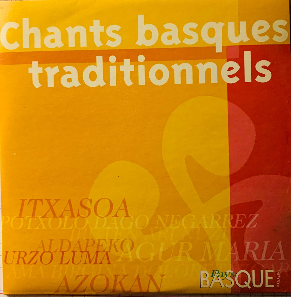 Vibrant yellow and red album cover with bold white typography for various artists chants basques traditionnels cd
