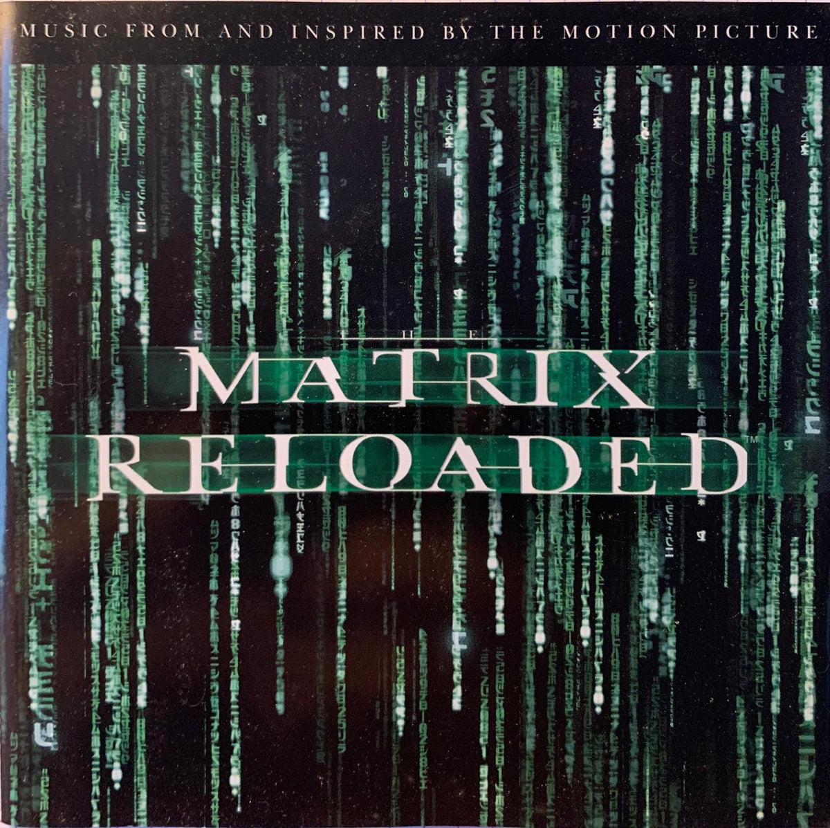 The matrix reloaded original motion picture soundtrack cd features a dark cover with green digital code design