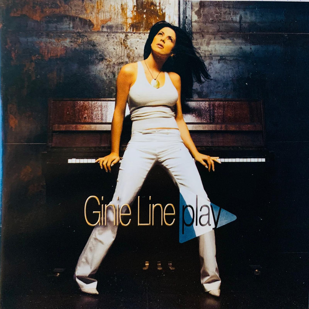 A woman in a white satin tank top and wide-leg pants poses confidently for various artists piano play compilation cd