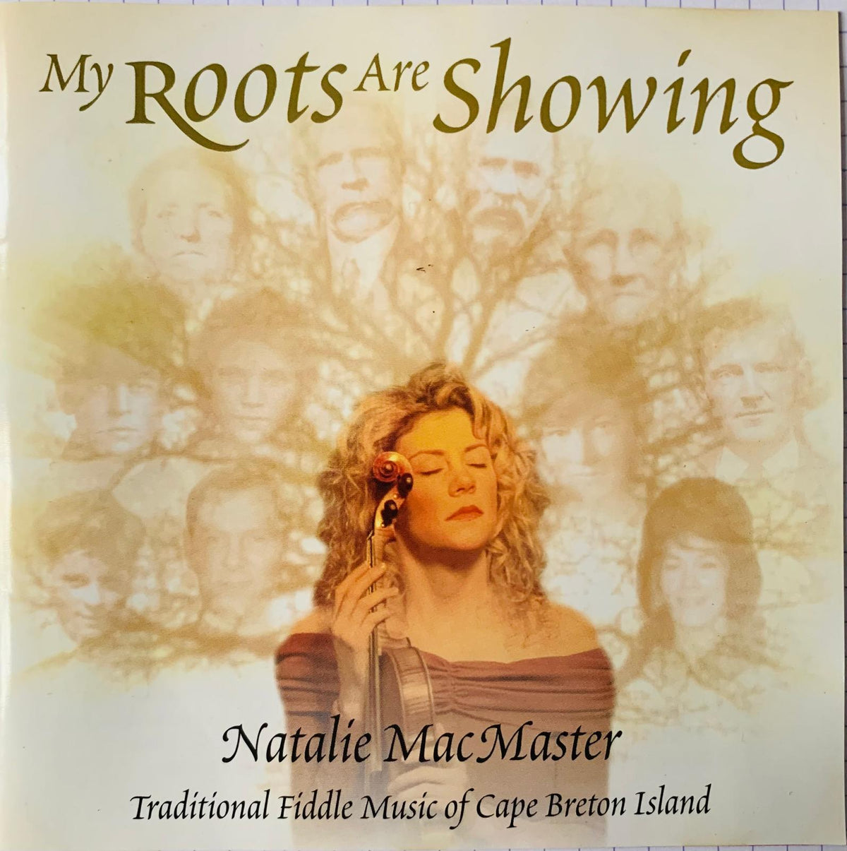 The album cover for natalie macmasters my roots are showing cd features a woman with curly blonde hair holding a violin