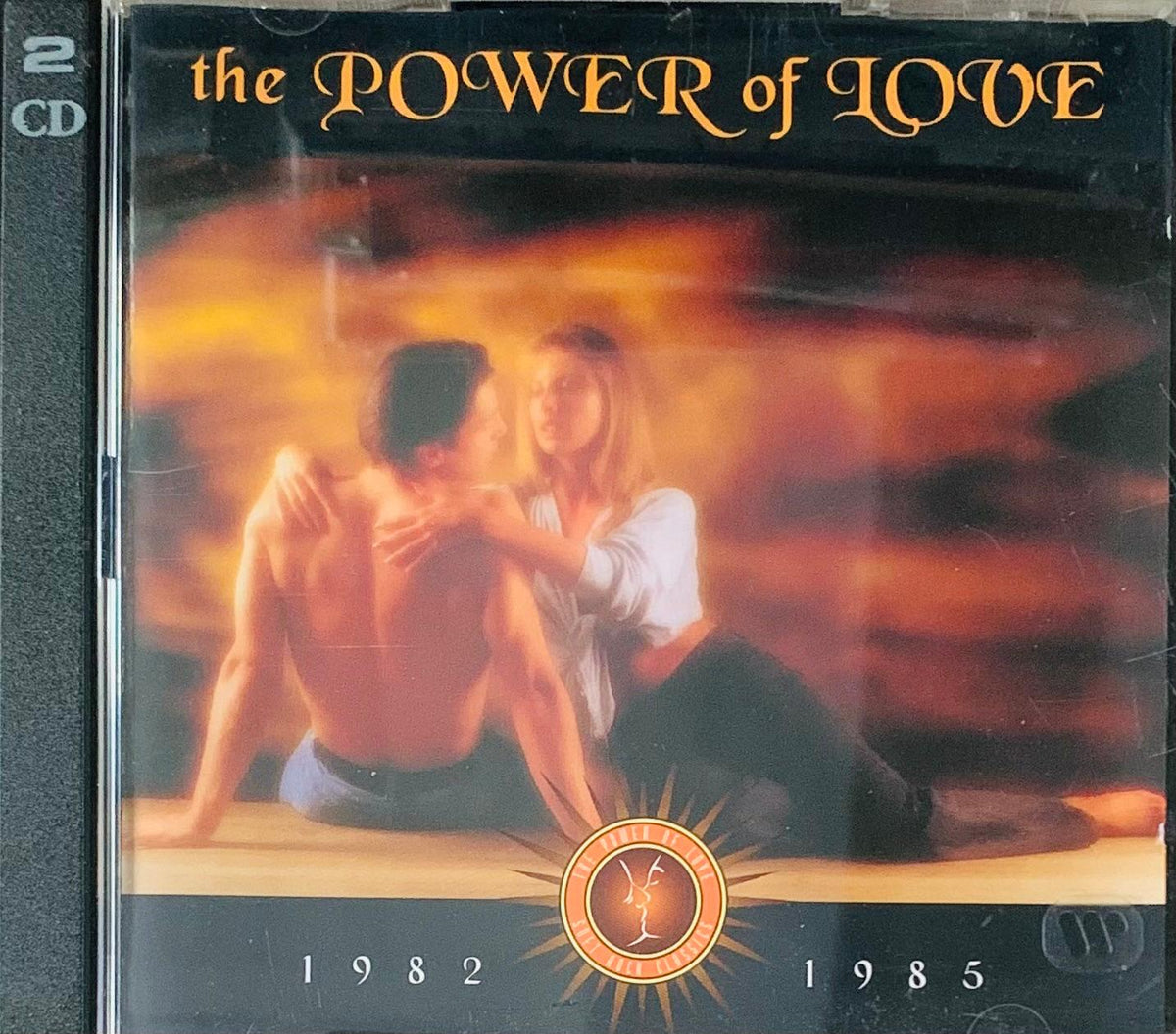 The power of love 2cd album cover shows two people embracing with warm orange and yellow lighting on a fiery backdrop