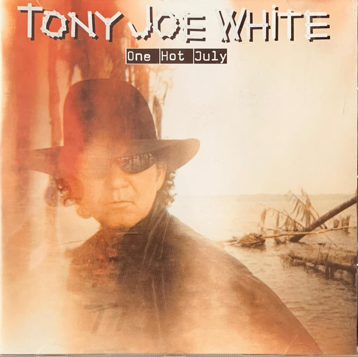 Tony Joe White one hot july original CD album cover with sepia portrait of artist wearing dark fedora and sunglasses