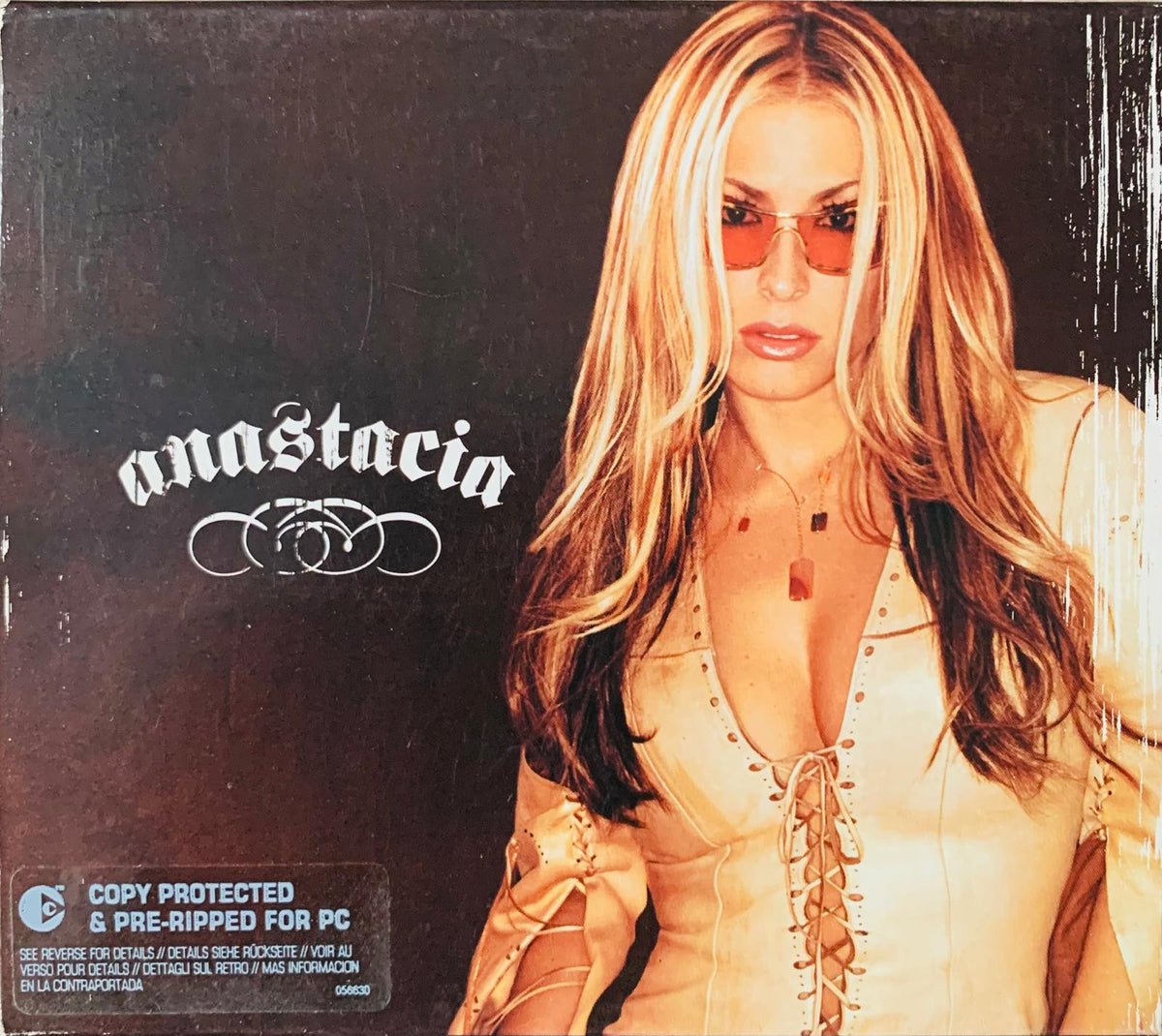 Anastacia original CD cover featuring a woman with long blonde hair wearing orange sunglasses and a beige lace-up top