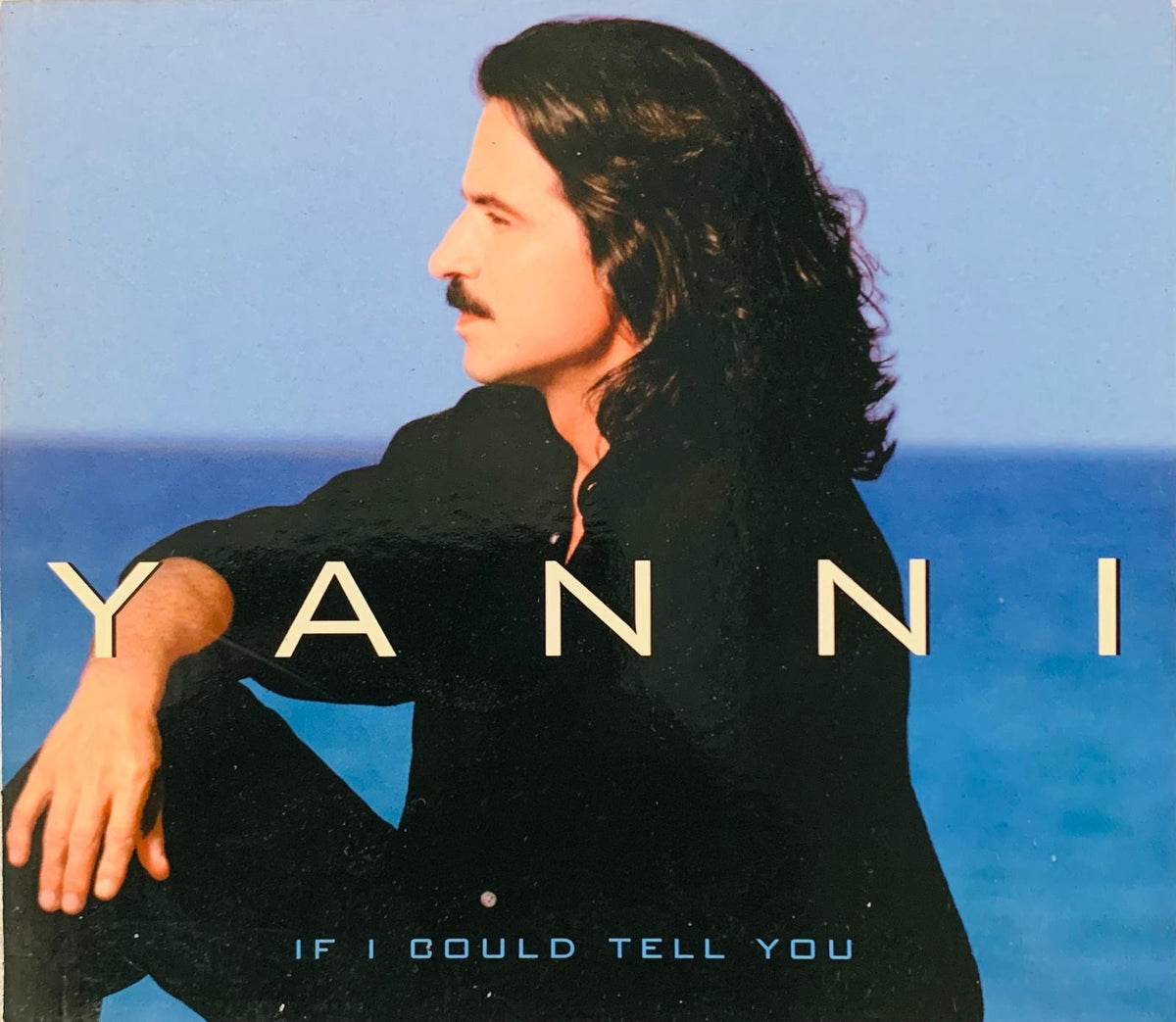 Yanni original cd if i could tell you album cover with man in black shirt and mustache against blue ocean background