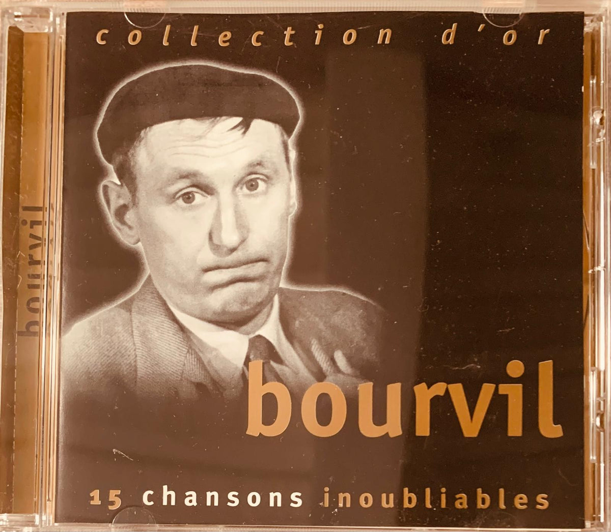Black and gold cd case featuring a sepia-toned portrait of bourvil with collection d’or in orange lettering