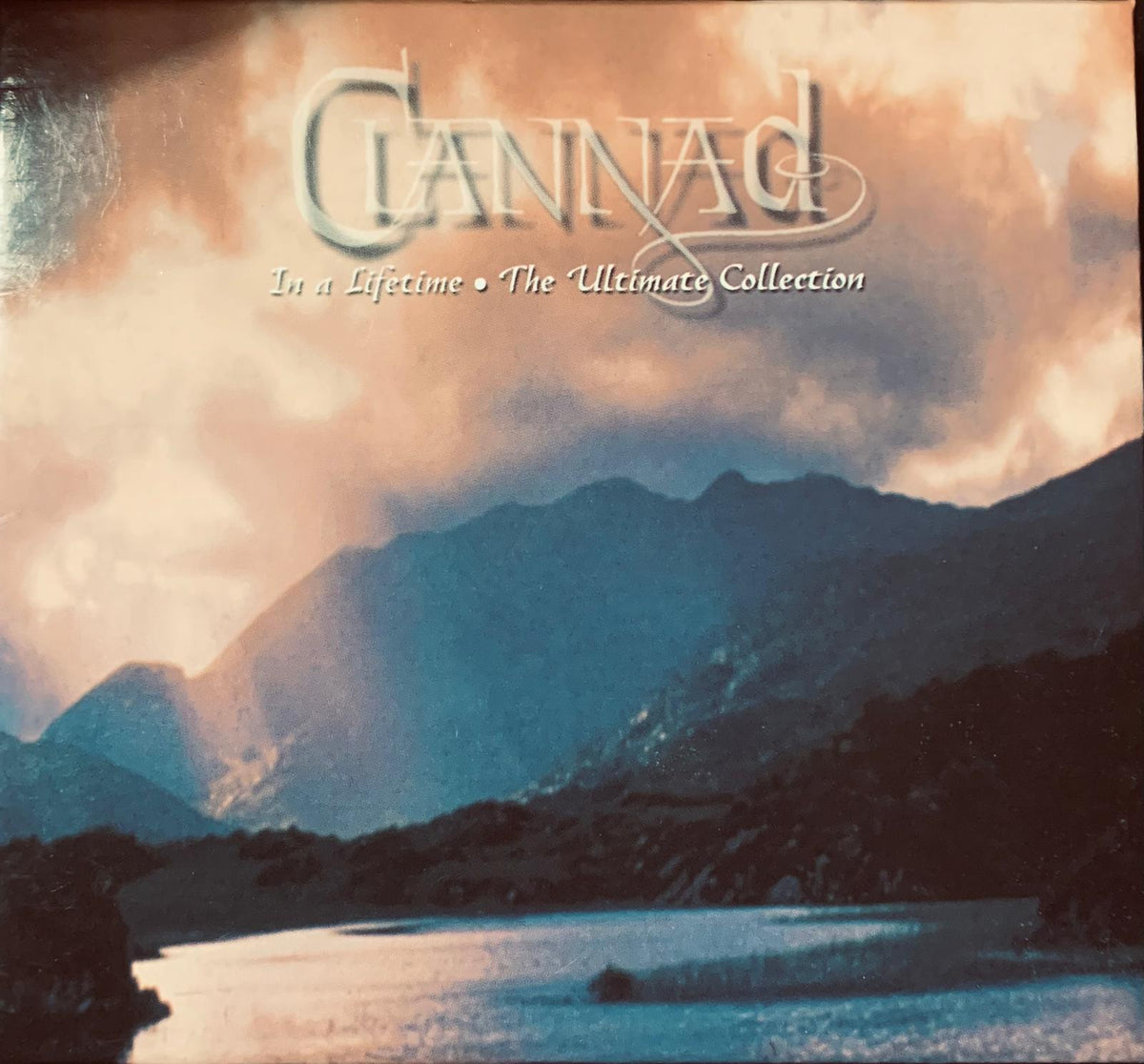 The album cover for clannad landmaks the ultimate collection features artistic mountains and water under a dramatic sky