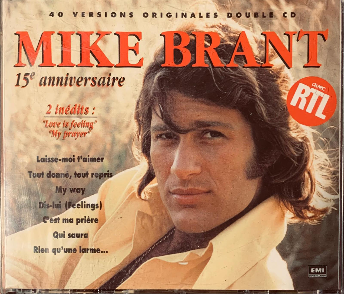 Mike Brant 15th anniversary double cd album cover with artist portrait in light jacket and orange-red title font
