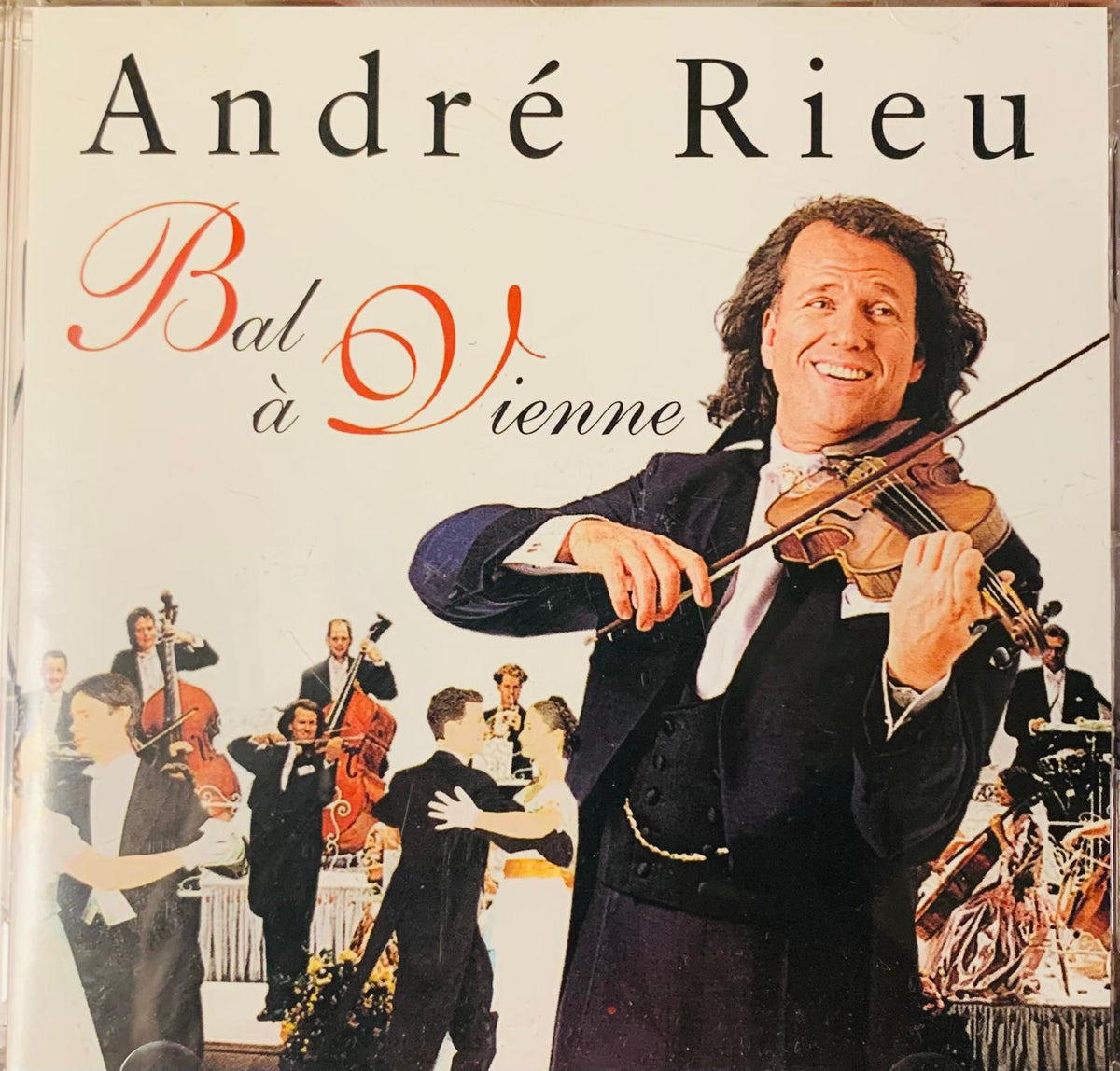 André rieu bal à vienne original cd cover with smiling violinist in formal attire against an orchestra and dancers backdrop