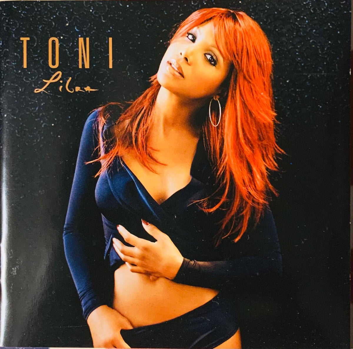 Toni Braxton Libra 2005 original CD cover featuring woman with vibrant red hair in dark blue velvet outfit