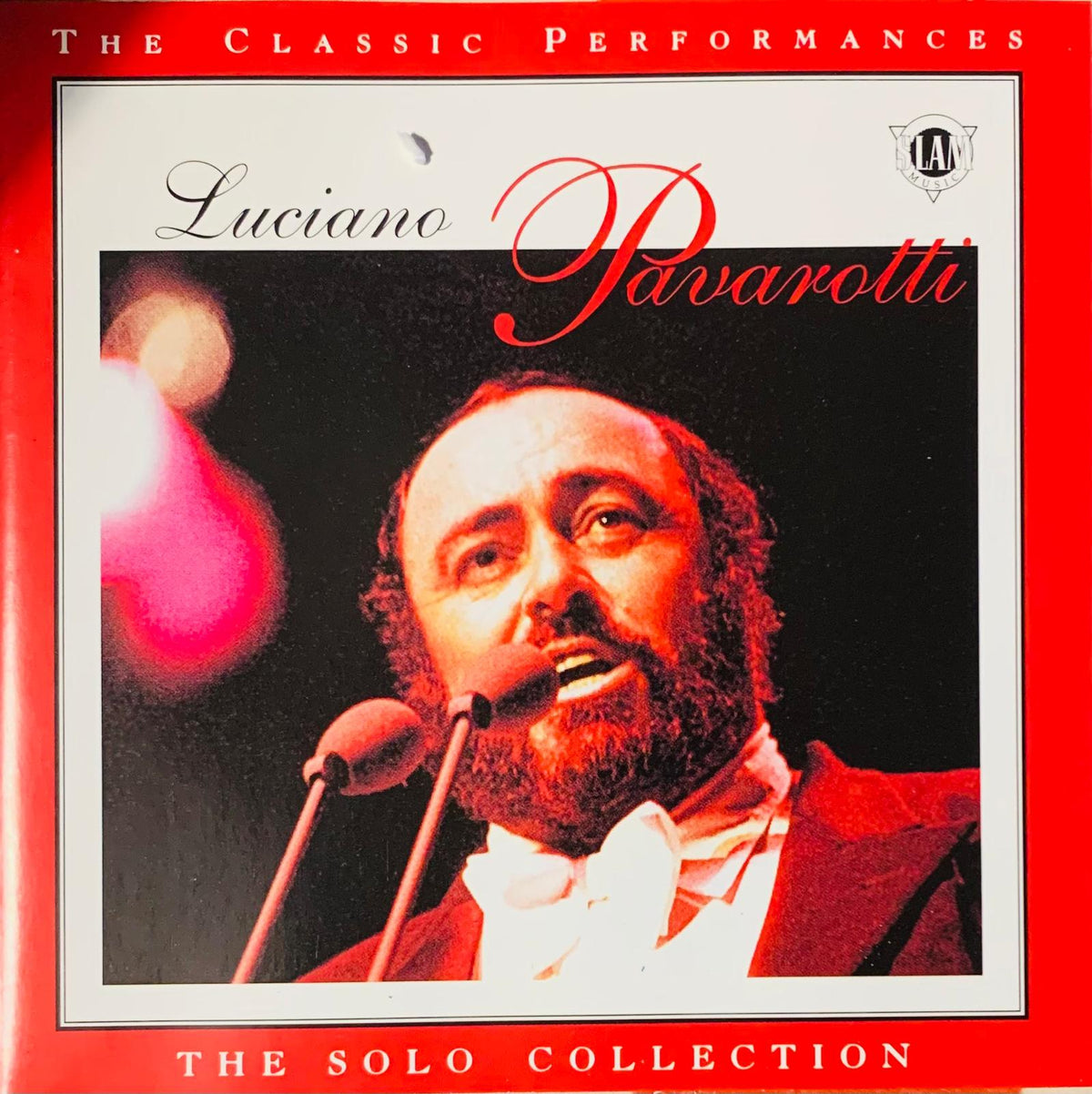 Red album cover of Luciano Pavarotti in formal attire titled the classic performances the solo collection original CD