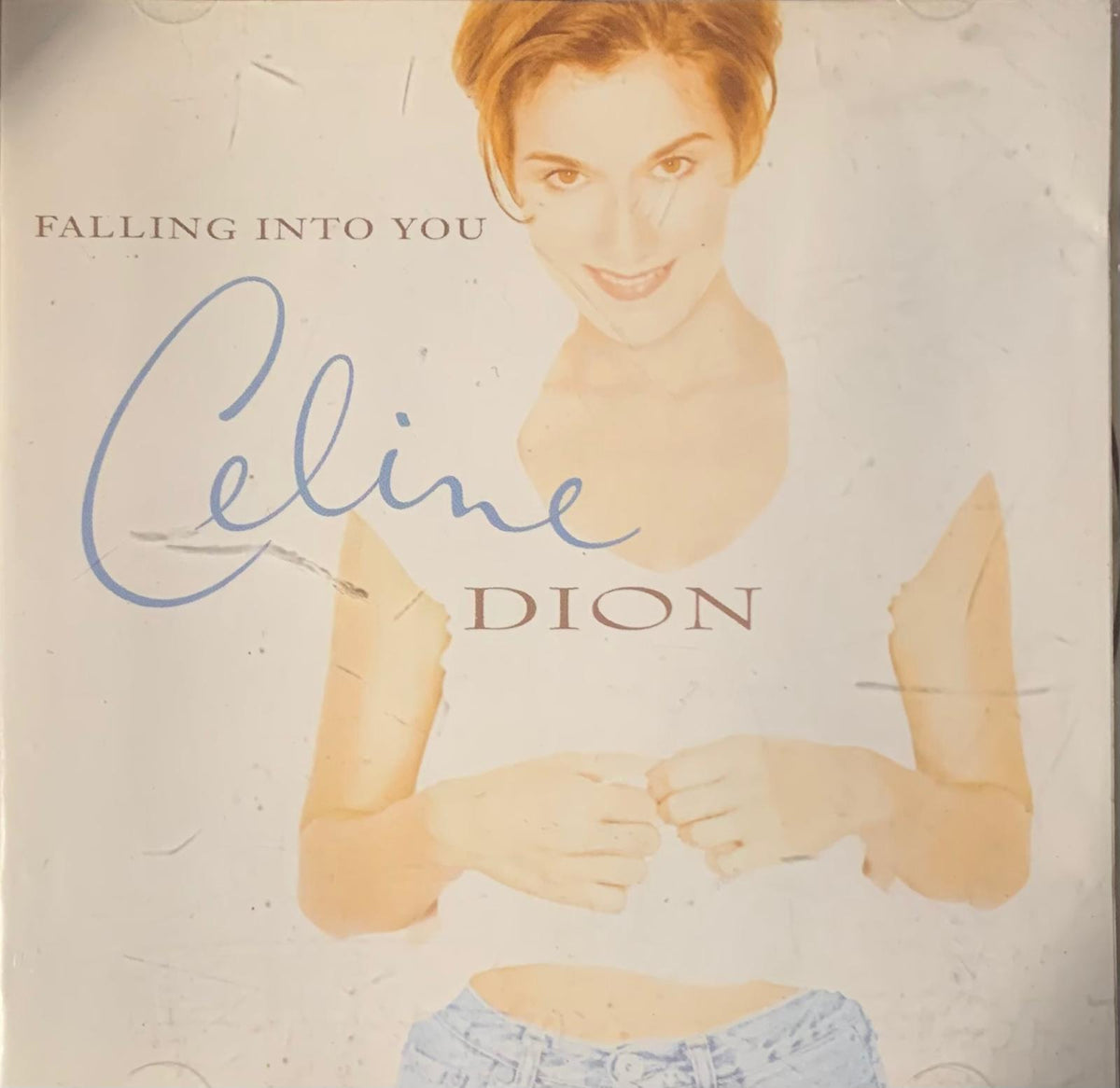 Céline Dion falling into you 1996 original CD cover featuring a stylized illustration in white top and light blue jeans