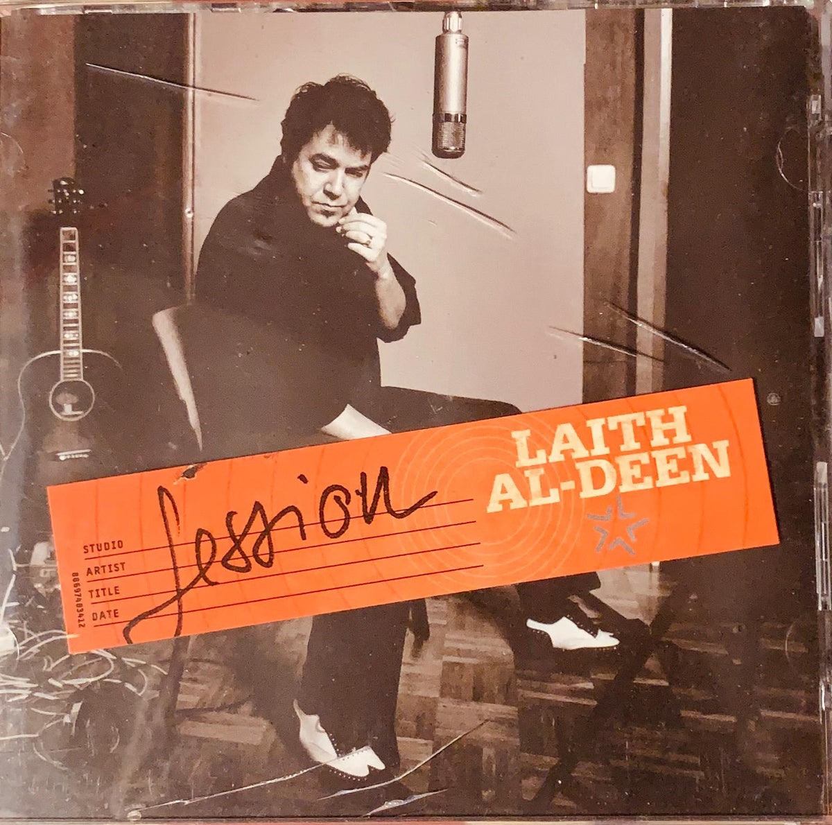 Orange cd case featuring a black and white photo of laith al deen in a studio with an orange lesson label