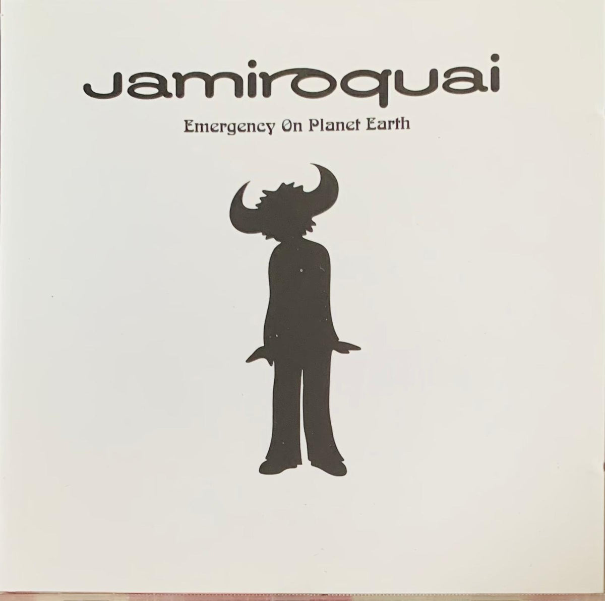 Black silhouette figure with horns on jamiroquai emergency on planet earth 1993 original cd album cover
