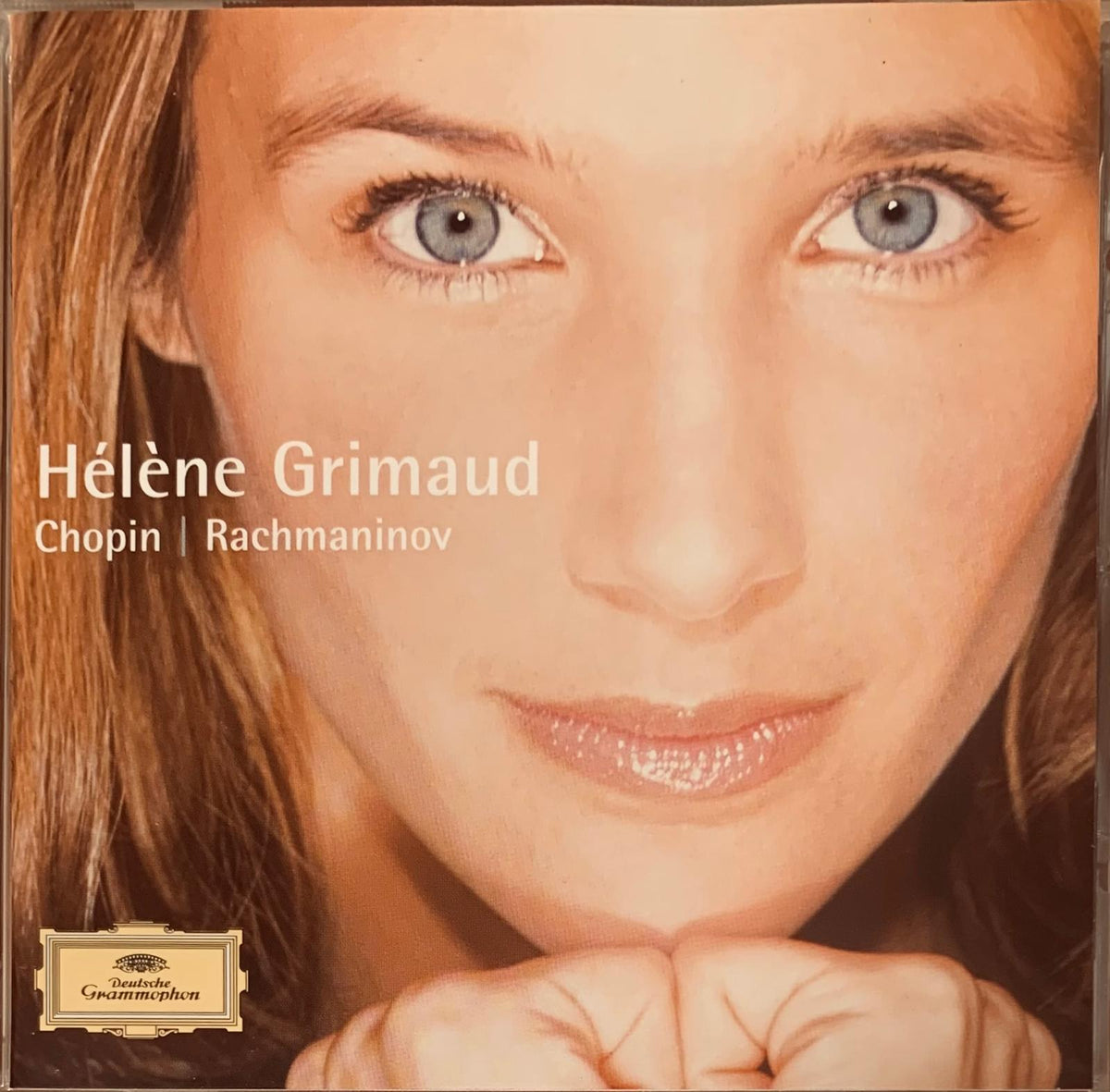 Close-up portrait of hélène grimaud with blue eyes and brown hair on the cover of hélène grimaud Chopin Rachmaninov cd