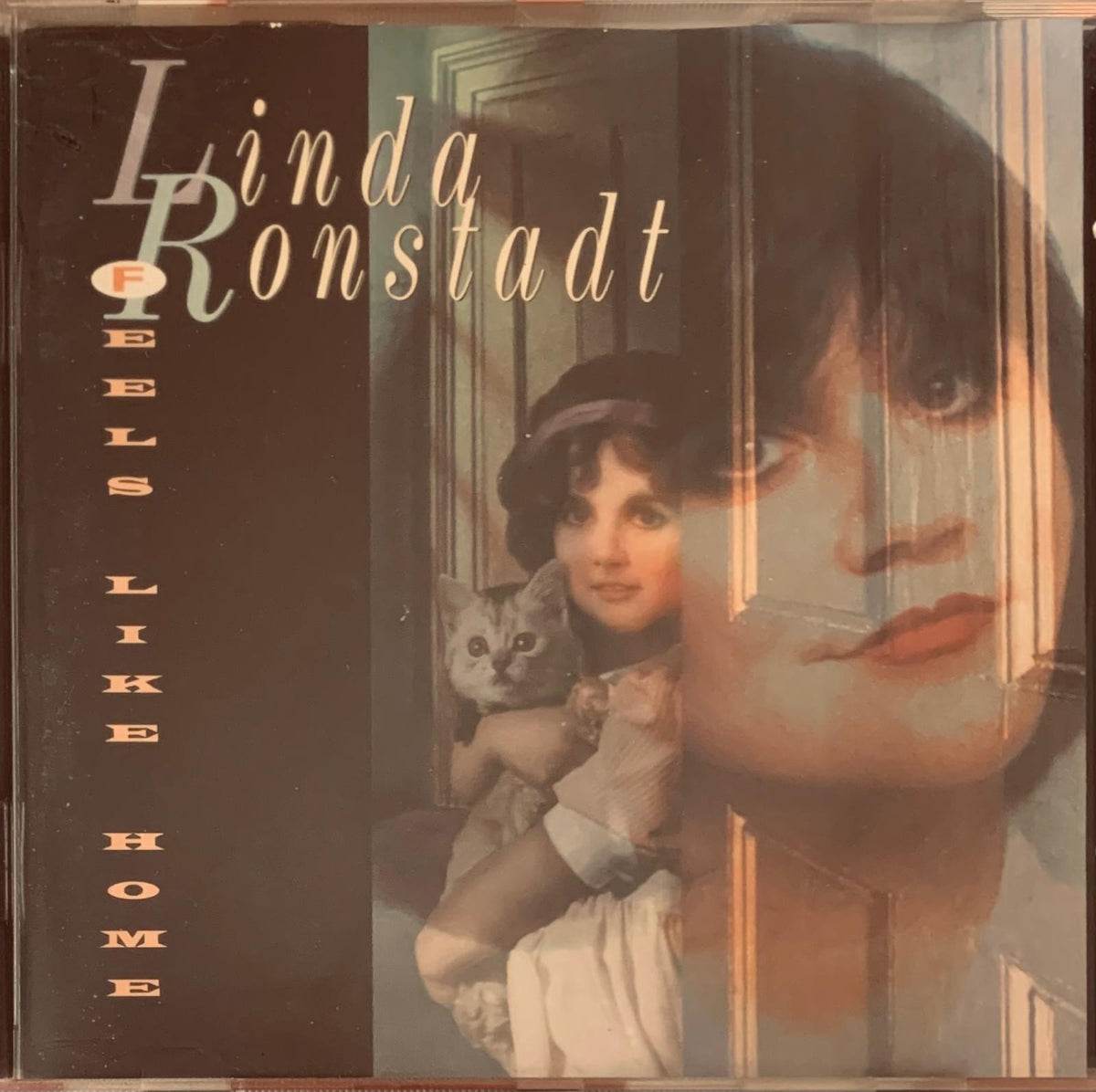 Linda Ronstadt feels like home 1995 original CD album cover featuring sepia-toned portrait holding a cat indoors
