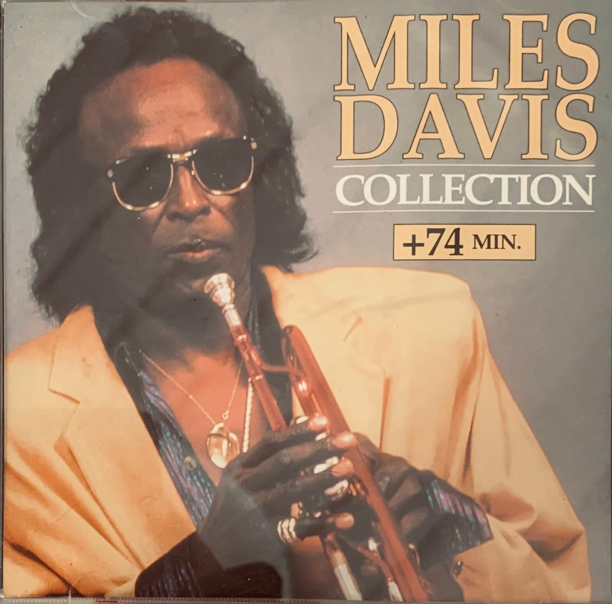 Miles Davis collection vinyl record album cover with jazz trumpeter portrait in sunglasses and tan suit holding trumpet
