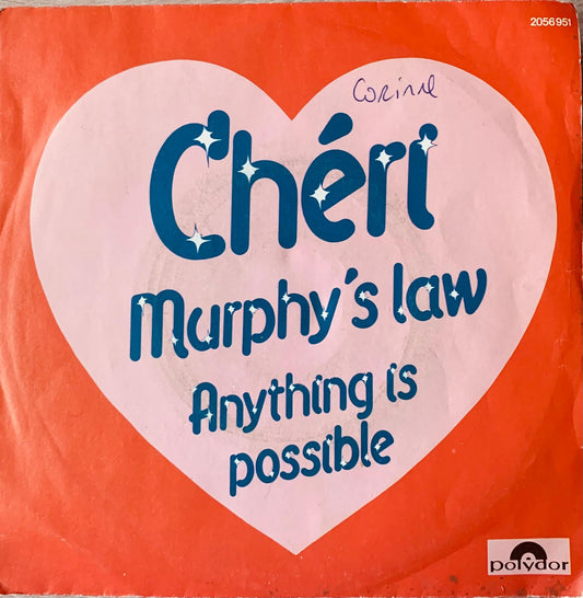 A vibrant orange vinyl record sleeve with a white heart and blue chéri murphys law text signed by corine