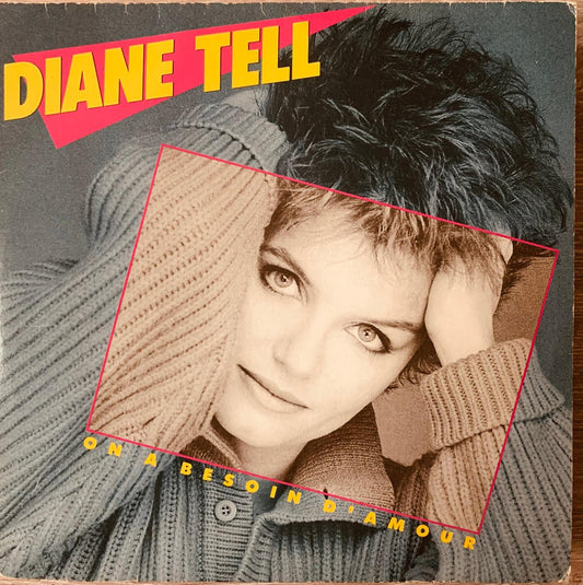 Diane Tell on a besoin d’amour 1980s vinyl album cover featuring artist in grey knit sweater with beige ribbed scarf