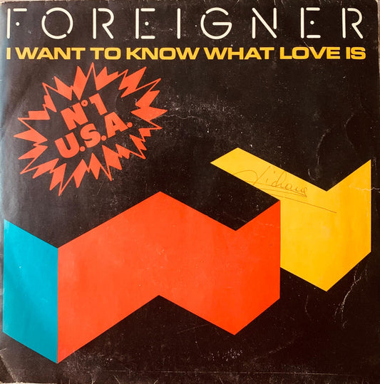Foreigner i want to know what love is 1984 vinyl album cover with bold red yellow and teal geometric shapes on black background