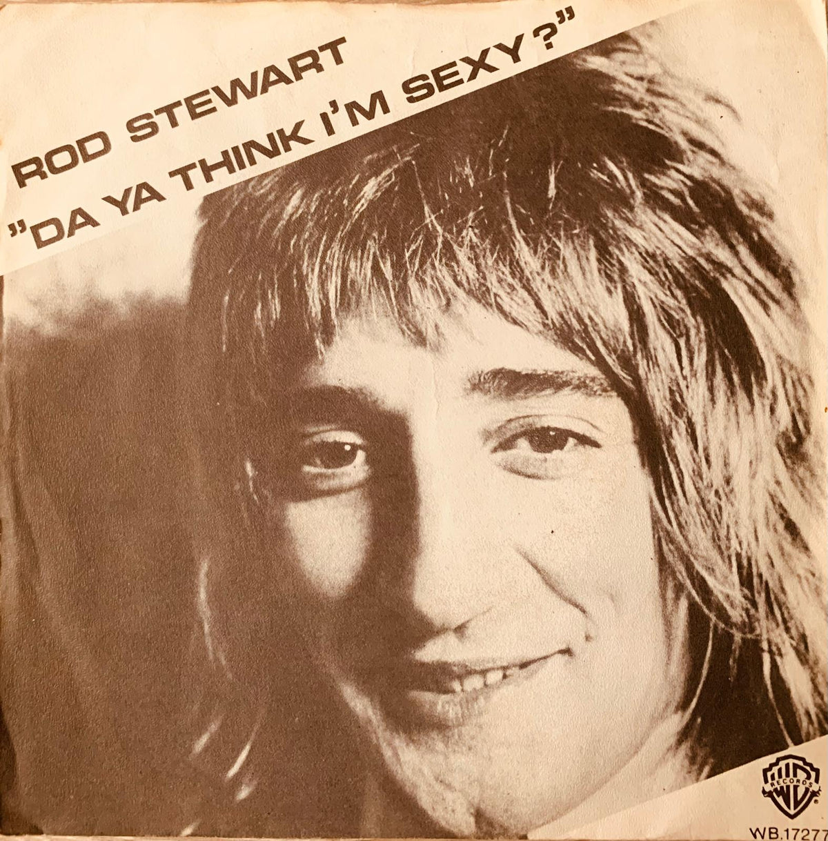Sepia-toned vinyl record sleeve of rod stewart with da ya think im sexy title diagonally printed on top from 1978