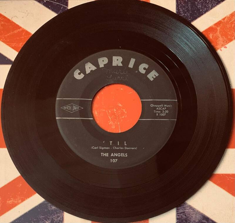 Black vinyl 7 inch record with bright orange caprice label featuring the song til by the angels from 1961 original us press