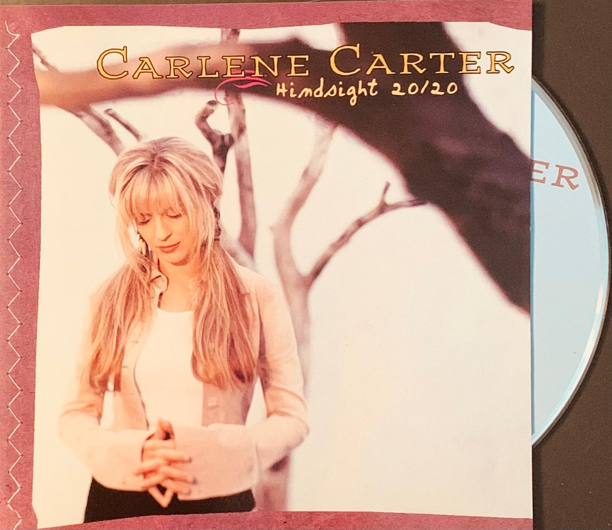 Carlene carter hindsight 20/20 original cd featuring soft-focus portrait in light jacket with bare tree branches background