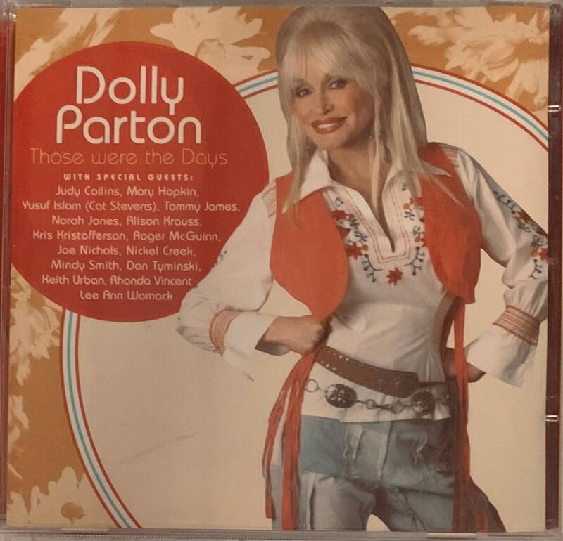 Dolly parton those were the days cd album cover featuring her portrait in white embroidered shirt orange vest and blue jeans
