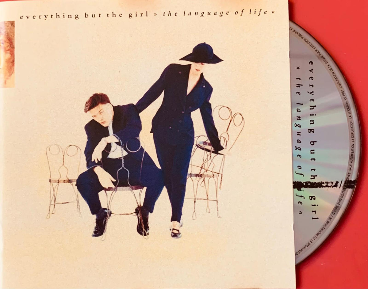 The album cover for everything but the girl the language of life features two figures in dark blue suits on off-white background